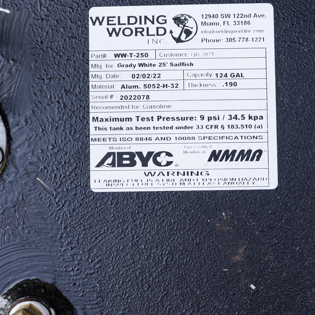Specification label for the 124-gallon aluminum fuel tank used in the 1989 Grady-White 25 Sailfish OEM replacement kit, manufactured by Welding World Inc. at their Miami, FL facility. The tank is identified as Part #WW-T-250 with Serial #2022078, built from .190″ thick 5052-H32 marine-grade aluminum and approved for gasoline use. Test pressure certified at 9 psi in accordance with 33 CFR § 183.510(a). The tank meets ISO 8846 and ISO 10088 standards, and the manufacturer is affiliated with ABYC and NMMA