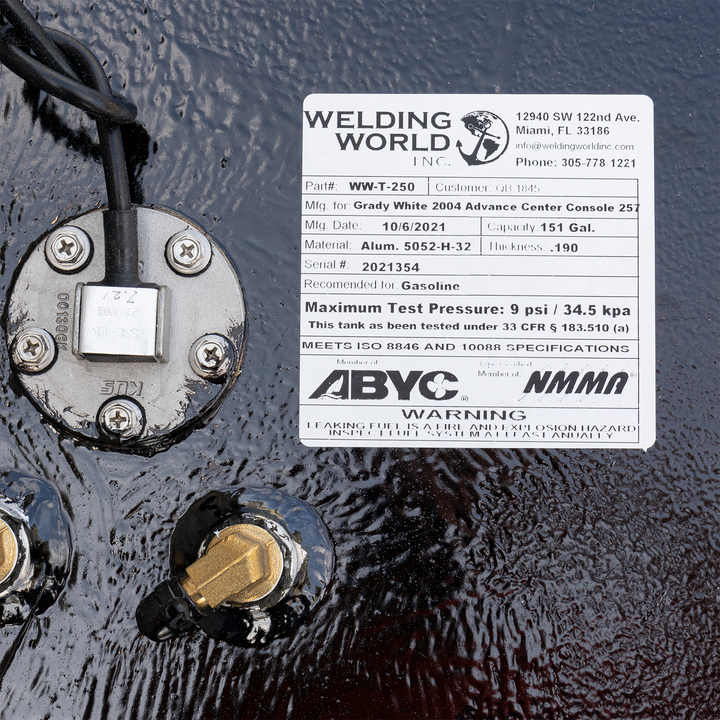 A label on a black fuel tank for a Grady White 2004 Advance Center Console 257, indicating it is a 151-gallon OEM replacement fuel tank manufactured by Welding World Inc. on 10/6/2021, made of Alum. 5052-H-32, with a serial number 2021354, recommended for gasoline, and a maximum test pressure of 9 psi / 34.5 kpa. The label also states it meets ISO 8846 and 10088 specifications and is certified by ABYC and NMMA
