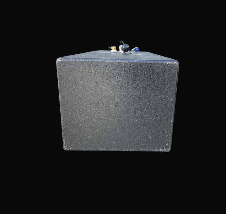 A studio front-facing end perspective view looking down the length of a physical, finished black encapsulated Grady White 272 Sailfish AUX OEM replacement marine fuel tank (52 gal) from file image_2a3454.jpg, isolated against a black background. Precision-fabricated from heavy-gauge marine-grade 5052-H32 aluminum, the rectangular end profile is fully encapsulated in a protective, textured black TarGard epoxy coating to resist severe saltwater pitting and bilge moisture decay. Mid-deck top fittings include a