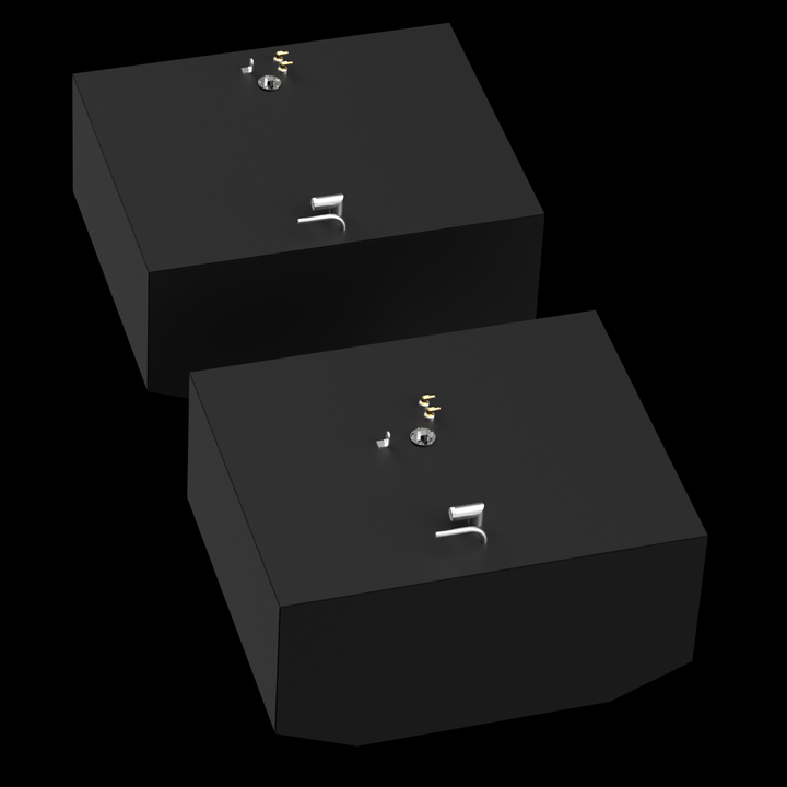 Two dark grey, rectangular fuel tanks are shown from an elevated, angled perspective against a black background with subtle white dots. Each tank has various golden and silver-colored fittings on its top surface, including pipes and valves. The tanks have angled bottom corners