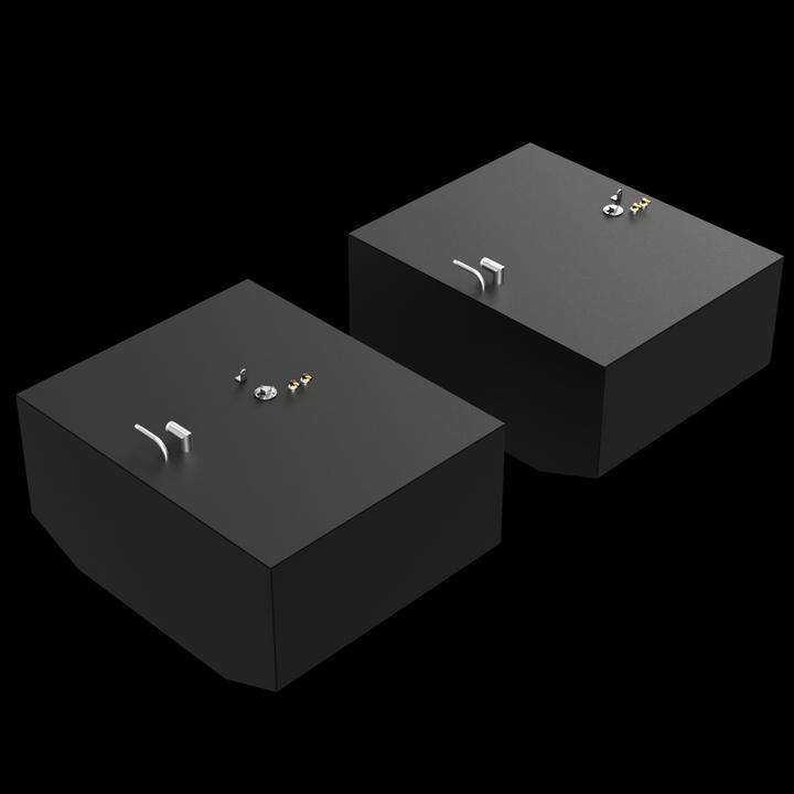 Grady White Bimini 306 OEM Replacement 2 Tandem Fuel Tank Combo Kit (156 & 150 gal.). The image shows two dark grey, rectangular fuel tanks, each with various golden and silver-colored fittings on their top surfaces, including pipes and valves. The tanks are positioned at an angle against a black background with subtle white dots. The tank in the foreground has a slightly rounded corner