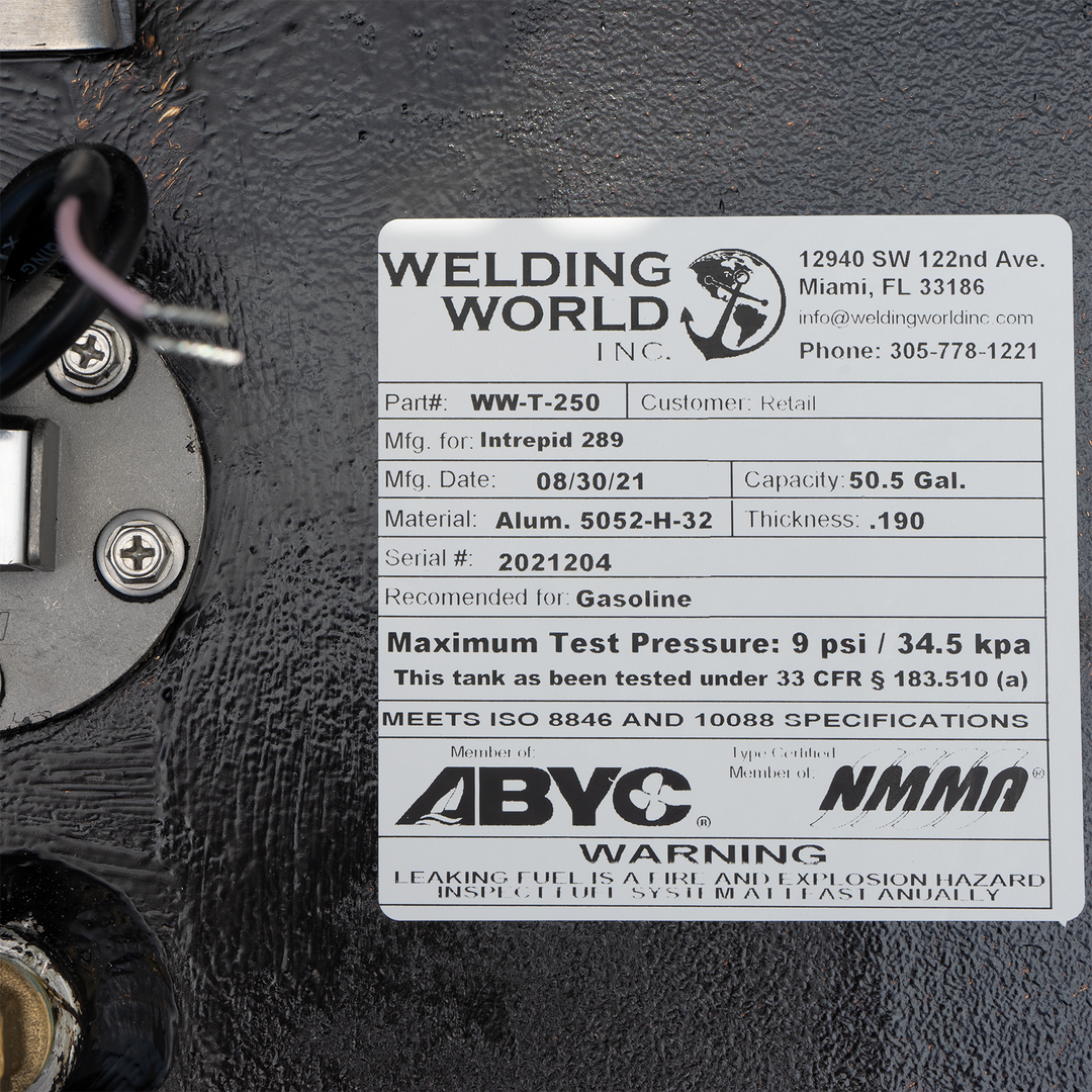 A white label on a black fuel tank, detailing specifications for a 50.5-gallon auxiliary fuel tank for an Intrepid 289, manufactured by Welding World Inc. on 08/30/21. The label includes the part number WW-T-250, material as Alum. 5052-H-32 with a thickness of .190, serial number 2021204, and states it is recommended for gasoline with a maximum test pressure of 9 psi / 34.5 kpa. It also notes that the tank meets ISO 8846 and 10088 specifications and is a member of ABYC and NMMA, with a warning about leaking