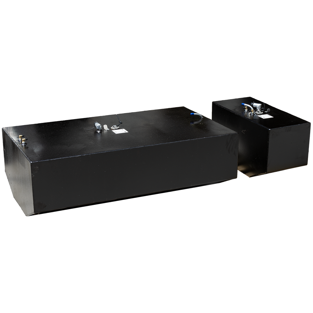 Two black fuel tanks, one larger in the foreground and one smaller in the background, are angled against a black and grey checkered pattern. Both tanks feature various metallic fittings on their top surfaces 