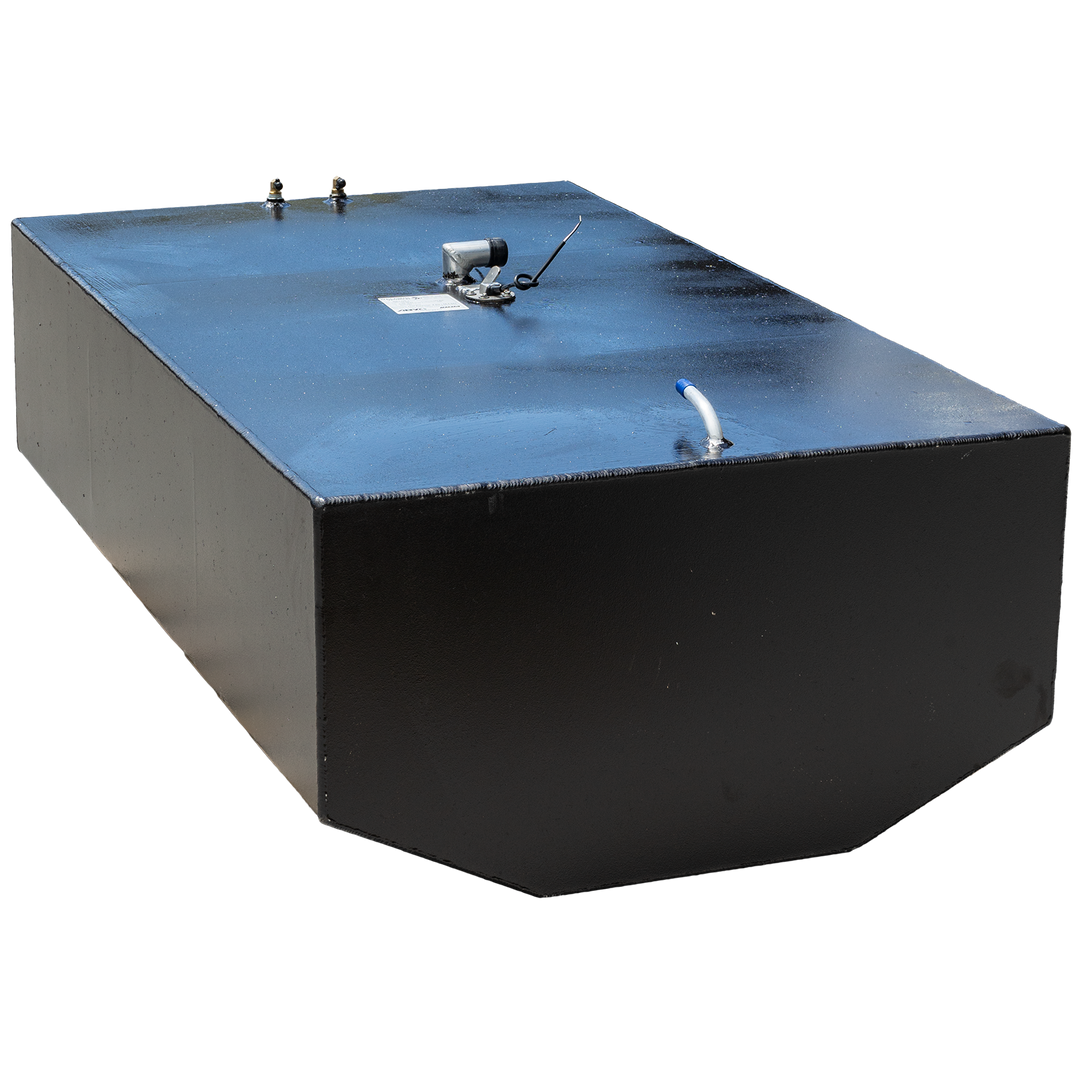 A black, rectangular fuel tank with multiple metal fittings on its top surface, including two brass-colored valves, a silver-colored pump, and a white tube with a blue tip. The tank is positioned against a black and grey checkered background