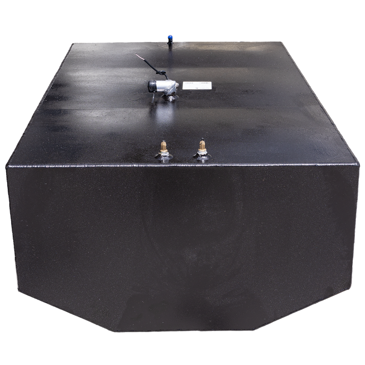 A black, rectangular fuel tank is shown at an angle against a black and grey checkered background. The top surface of the tank features various fittings, including two brass-colored valves and a silver-colored component with wires attached, and a blue-tipped tube in the background