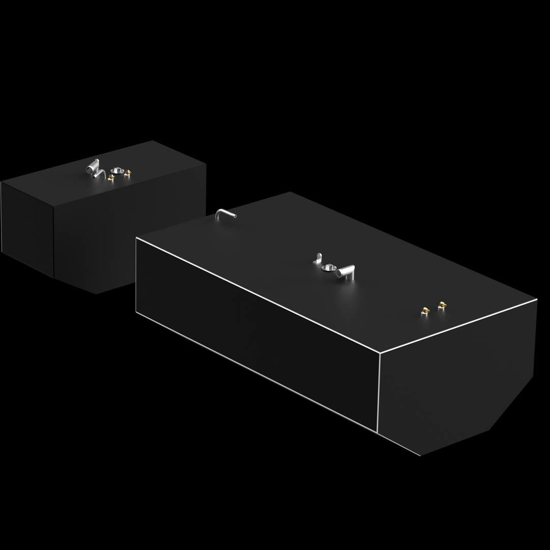 Two dark gray, rectangular fuel tanks are shown against a black background. The larger tank is in the foreground and has a thin white outline along its top edges, with several metallic fittings on its surface, including two small brass-colored ones and a larger silver-colored set. The smaller tank is positioned behind and to the left of the larger one, also featuring metallic fittings on its top surface