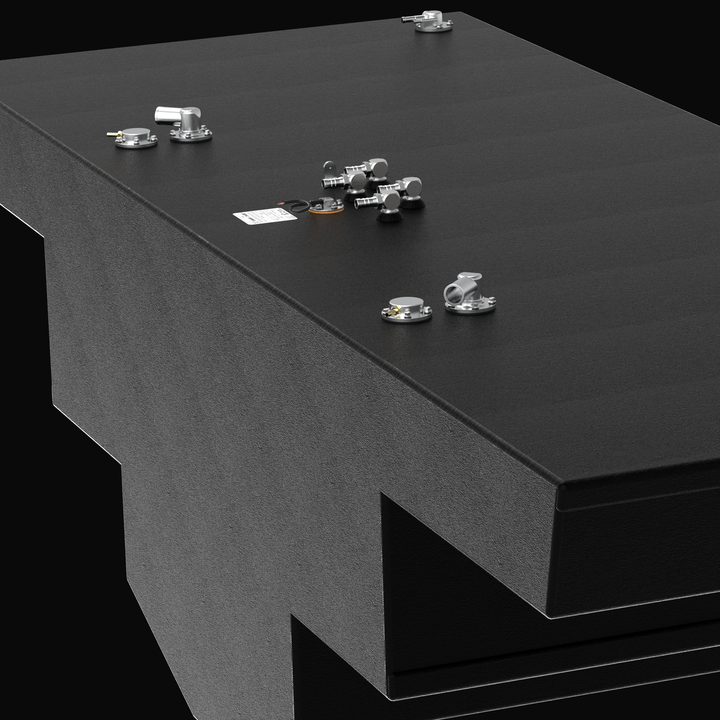 Close-up perspective detail view focusing on the upper deck hardware configuration and textured coating of an Intrepid 475 Open Spec OEM replacement marine fuel tank. The image highlights the side tier transition of the stepped hull-conforming geometry, showcasing a heavy-gauge marine-grade 5052-H32 aluminum tank assembly fully encapsulated in a protective black TarGard epoxy coating. Pre-installed hardware on the expansive deck surface includes a clustered four-port bank of brass 90-degree fuel pickup elbo
