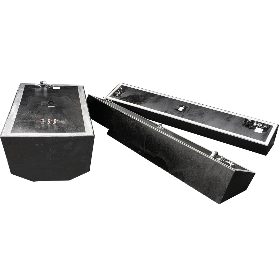 Three black fuel tanks, one large rectangular tank and two smaller, elongated rectangular tanks, are displayed against a checkered background. The large tank is on the left, and the two smaller tanks are positioned diagonally behind and to the right of it. All tanks have various fittings and connections on their top surfaces