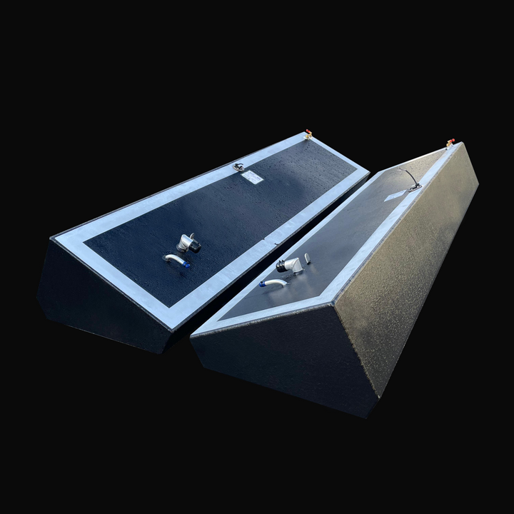 A photo of the Island Runner 104-gallon port and starboard Built to OEM Specs fuel tanks for a 31' 1998 model, showing the pair of long, dark, textured, wedge-shaped tanks angled side-by-side against a black background.