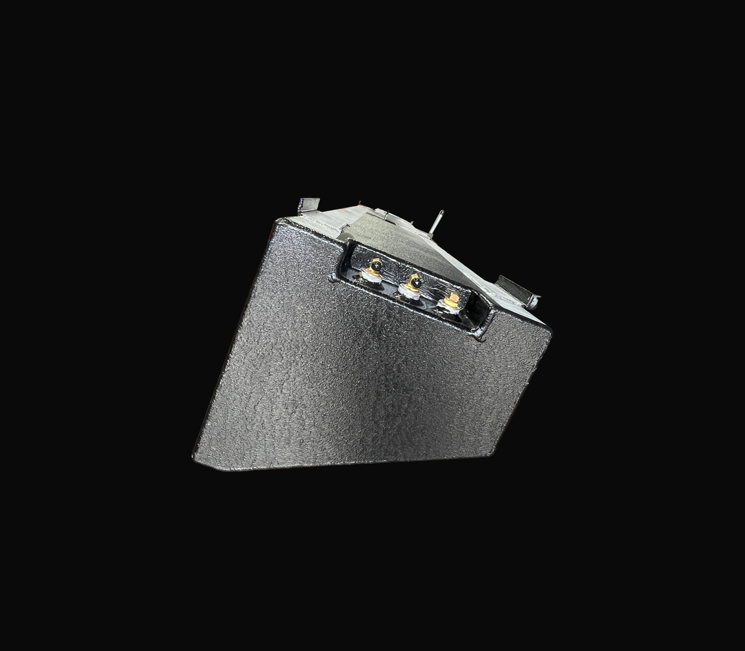 A close-up end elevation perspective view of a single physical, finished black encapsulated Jupiter 31 Cuddy port or starboard OEM replacement saddle fuel tank (105 gal) from file image_4a9222.jpg, isolated against a black background. This detailed end shot highlights the custom-angled cross-sectional profile precision-fabricated to match the vessel's outboard hull deadrise geometry. Heavy-gauge marine-grade 5052-H32 aluminum is coated in a textured, anti-corrosive black TarGard epoxy coating to protect aga