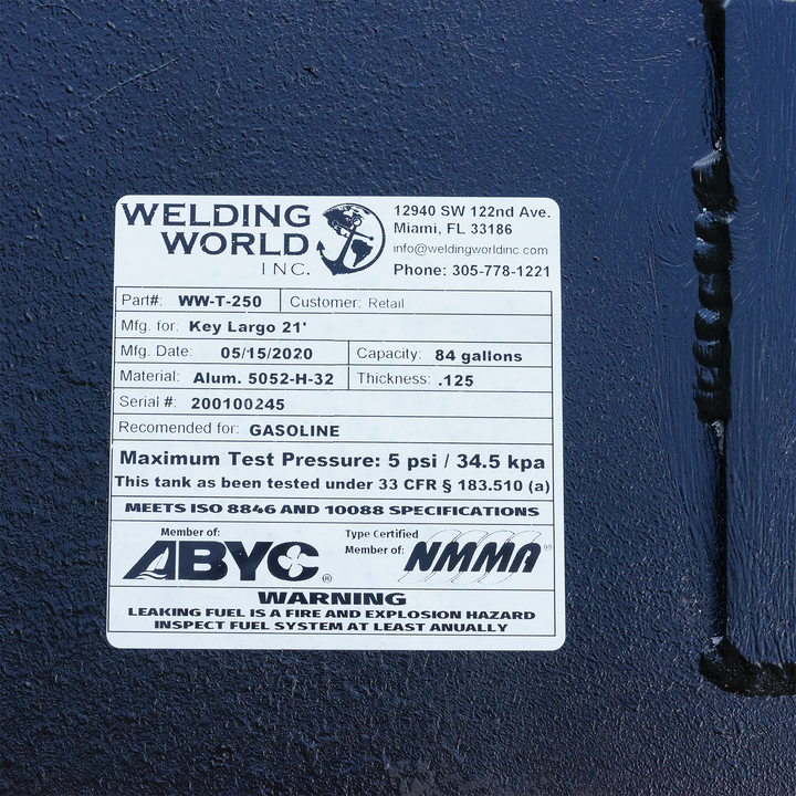 Label on a Key Largo 21' OEM replacement belly fuel tank, detailing specifications including model number, manufacturer, capacity of 84 gallons, material (aluminum), maximum pressure (5 psi), and safety certifications