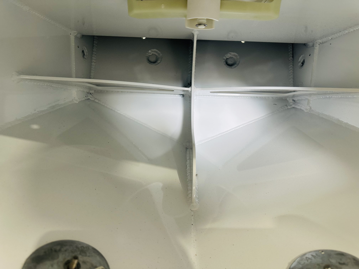 Interior view of a Mako 20 1980 high flotation engine bracket, showcasing the white-painted metal structure with visible welds and mounting holes