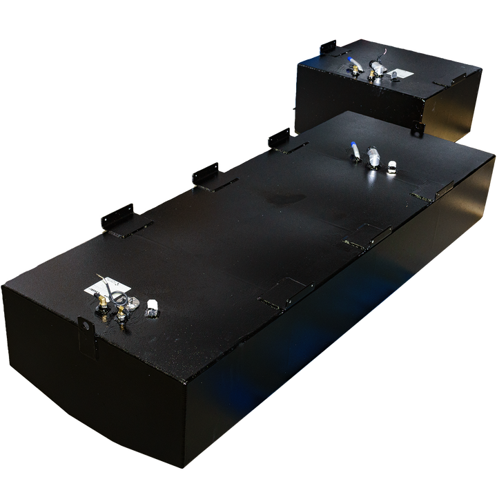 An elevated view of two black rectangular fuel tanks, part of a Mako 252 - 1999 OEM Replacement Belly Fuel Tank Combo Kit, designed to hold 142 and 51 gallons respectively. The tanks have a slightly textured finish and feature various metallic fittings and connections on their top surfaces. The tanks are placed on a black and grey checkered surface, with light reflecting off their sides