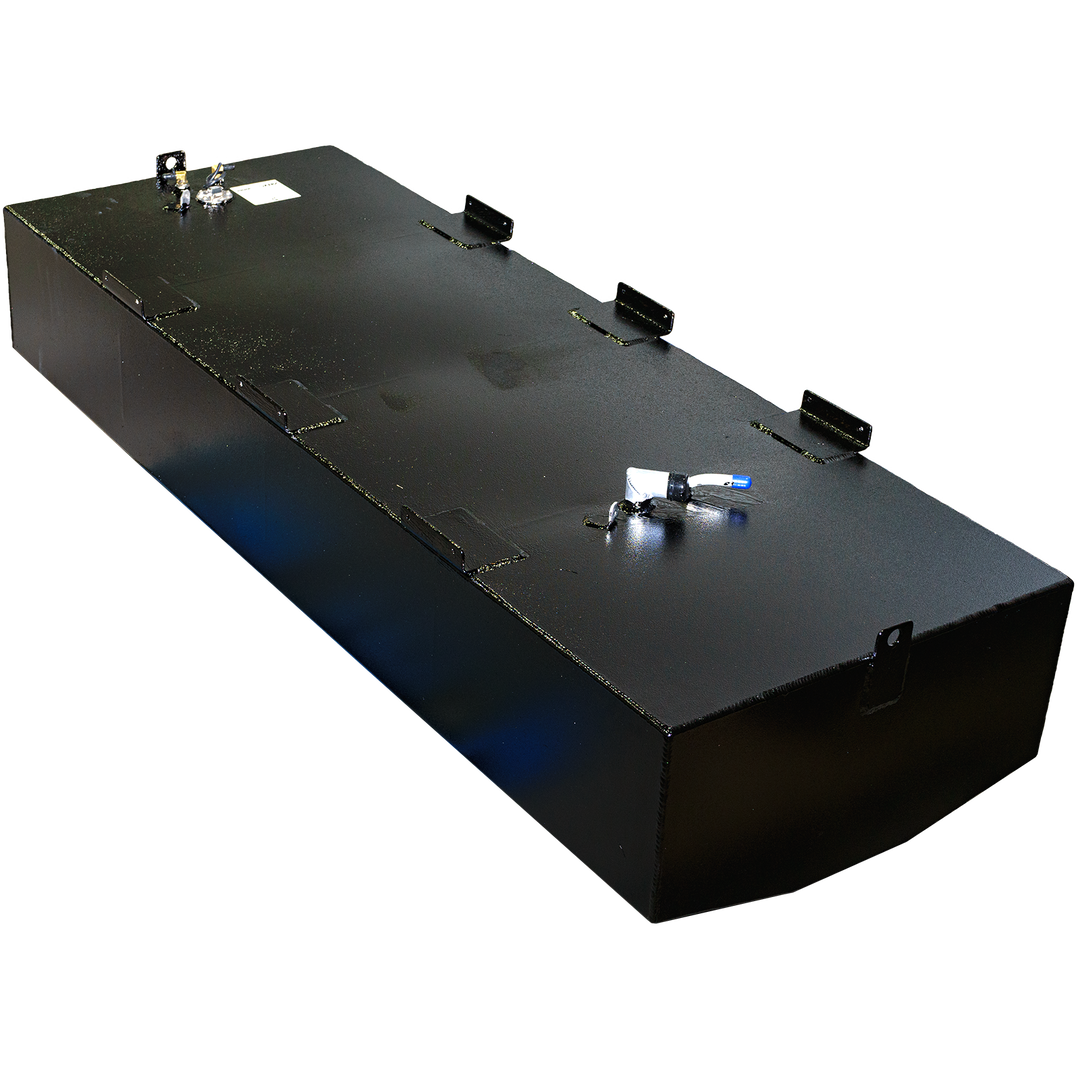 A black, rectangular fuel tank with a coarse, textured finish is shown from an elevated perspective. Various metal fittings and mounting brackets are visible on its top surface. The bottom left edge of the tank is rounded. The background is a checkerboard pattern of black and gray squares