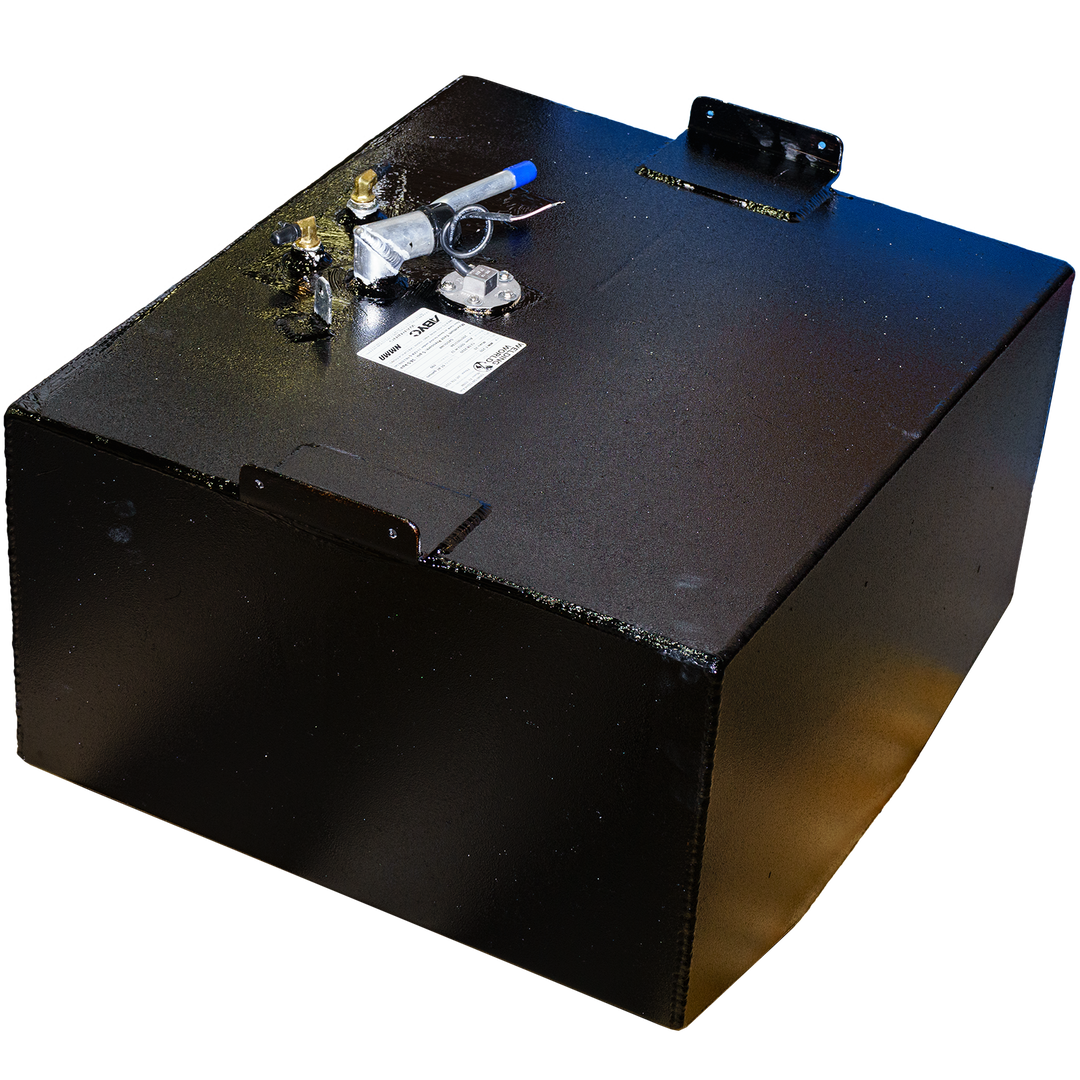 An elevated, angled shot of a black, rectangular fuel tank with a textured surface, designed for a Mako 252 - 1999 model with a 51-gallon capacity. The tank features various metal fittings and connections on its top, including a blue-capped tube and a round plate with visible screws. Mounting brackets are also present on the top surface. The bottom left edge of the tank is angled. The background is a checkerboard pattern of black and grey squares