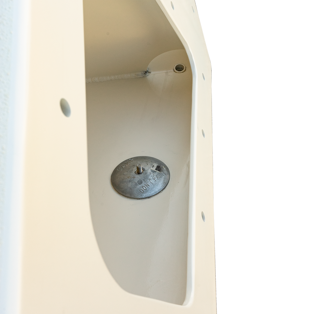 Close-up view of a high flotation bracket from a 1987 Mako 258 Cuddy twin engine boat, featuring a circular metal plate with three screws inside a white fiberglass structure