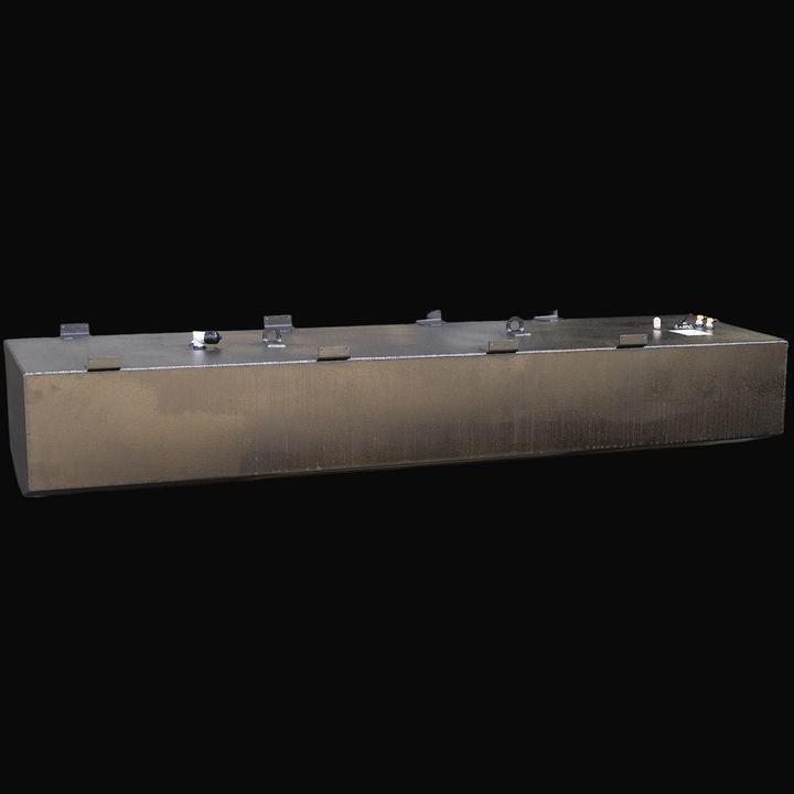 Long rectangular black metal fuel tank with welded mounting brackets along the top edges, several fittings and a fuel sending unit on top, photographed at an angle showing the front and top surfaces with a textured finish