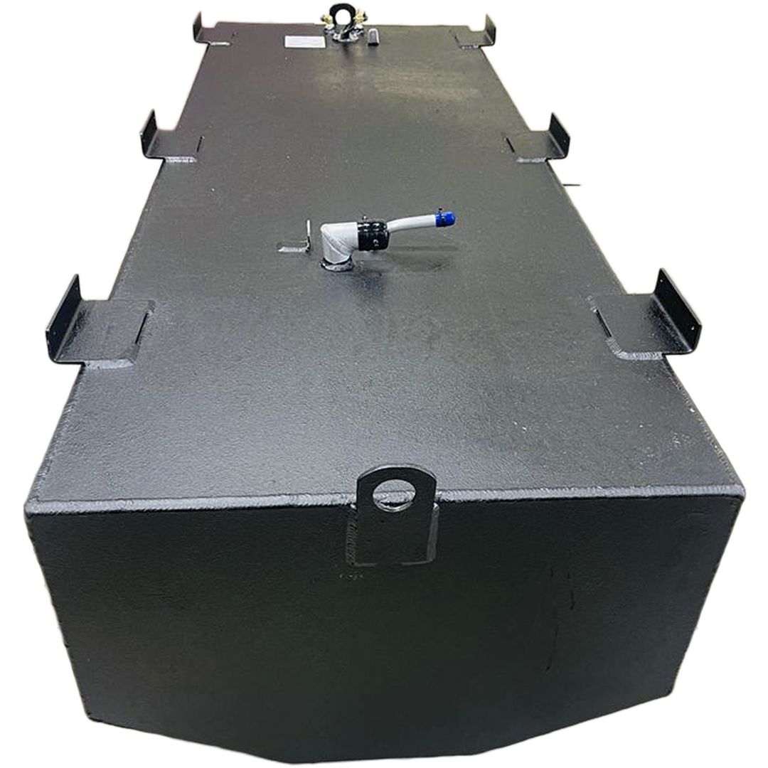 A dark grey, irregularly shaped metal tank with a textured surface is shown from an elevated perspective against a black and grey checkered background. The tank's top features several L-shaped mounting brackets along its edges, and various fittings, including a white, curved pipe with a blue tip, and a cluster of nozzles and a white label at one end. The bottom edge of the tank is slightly curved