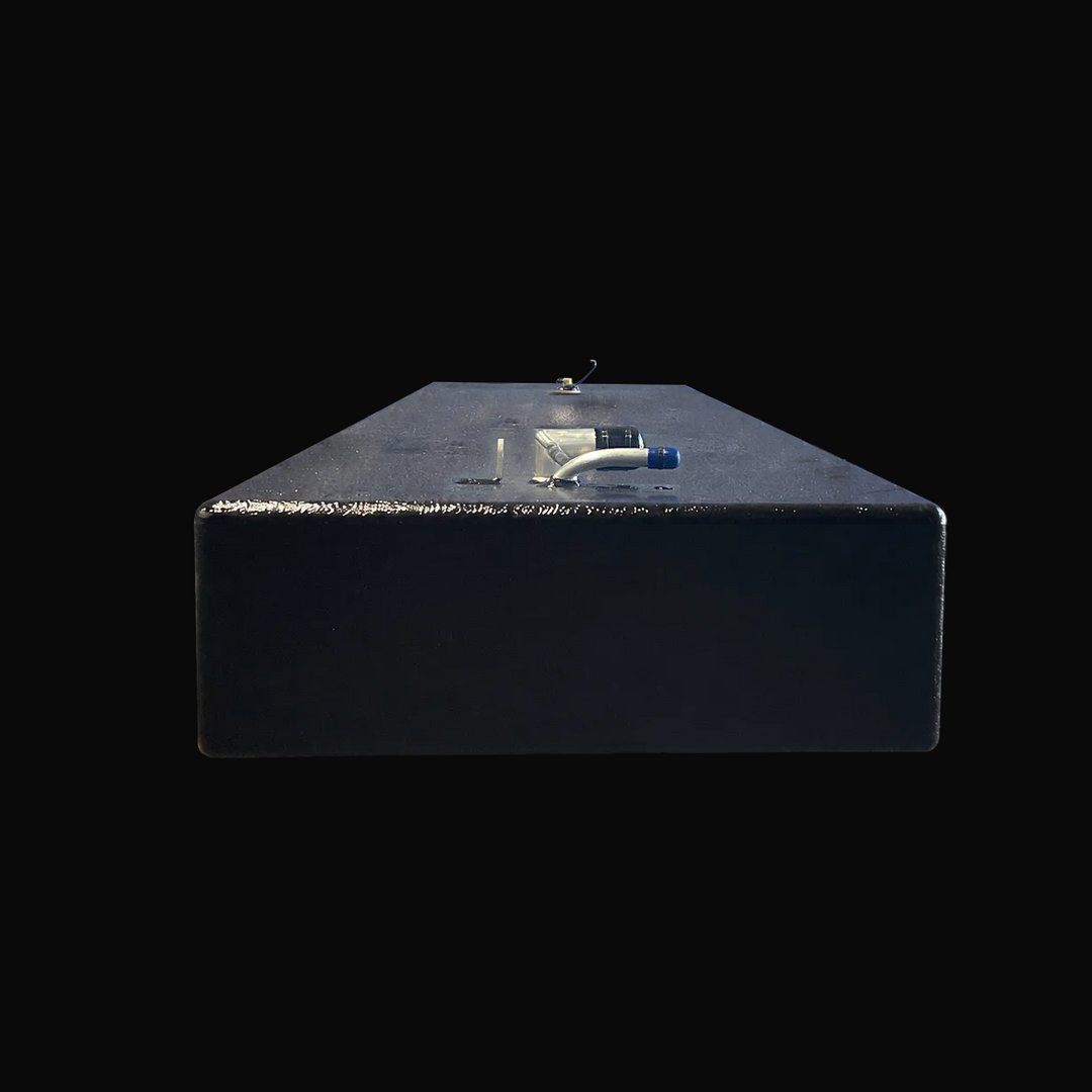 A studio low-angle front end view highlighting the slim 8-inch height and flat hull-conformed base of a physical, finished black encapsulated Paramount 21 2025 OEM replacement marine fuel tank (84 gal) from file image_c20c07.png, isolated against a black background. Precision-fabricated from heavy-gauge .190" marine-grade 5052-H32 aluminum, the elongated rectangular body is fully encapsulated in a protective, textured black TarGard epoxy coating to resist severe saltwater pitting and bilge moisture decay. T