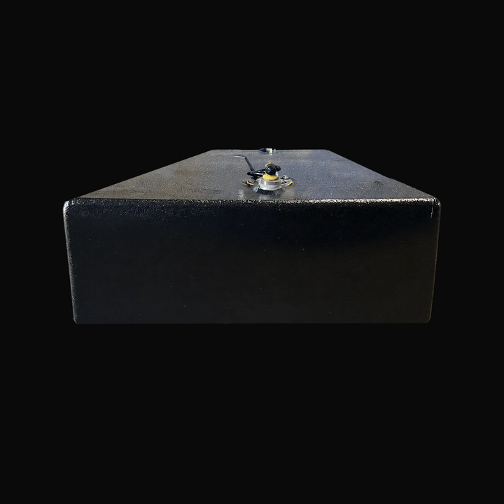 A studio low-angle rear end perspective view highlighting the 8-inch low profile and flat hull bottom of a physical, finished black encapsulated Paramount 21 2025 OEM replacement marine fuel tank (84 gal) from file image_c21384.jpg, isolated against a black background. Precision-fabricated from heavy-gauge .190" marine-grade 5052-H32 aluminum, the elongated rectangular body is fully encapsulated in a protective, textured black TarGard epoxy coating to resist severe saltwater pitting and bilge moisture decay