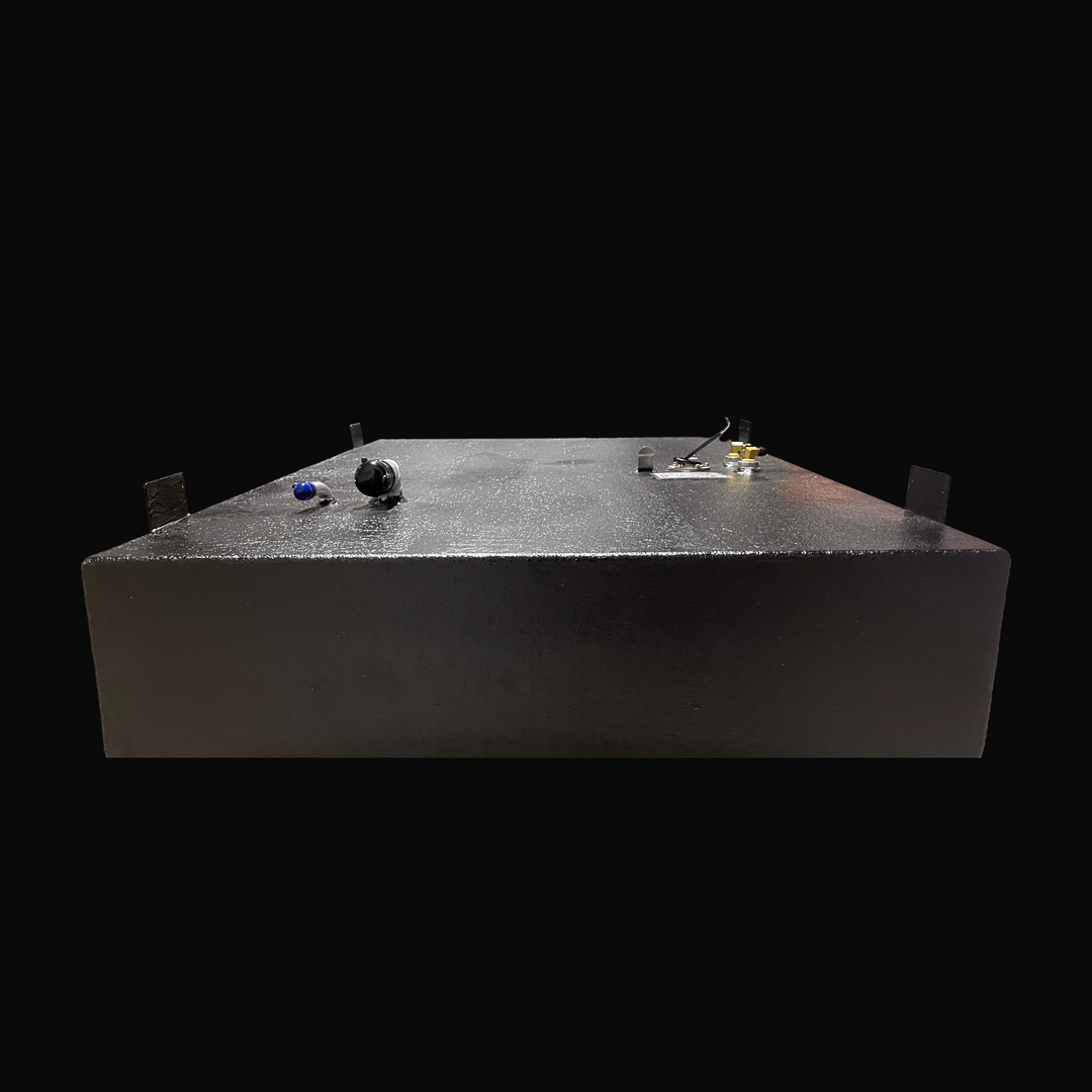 A studio front-facing elevated end perspective view looking across the main deck of a physical, finished black encapsulated Parker 2120 Sport Cabin OEM replacement marine fuel tank (102 gal 2003) from file image_bc68a0.jpg, isolated against a black background. Precision-fabricated from heavy-gauge marine-grade 5052-H32 aluminum, the wide low-profile body is fully encapsulated in a protective, textured black TarGard epoxy coating to resist severe saltwater pitting and bilge corrosion. Four heavy-duty, uprigh