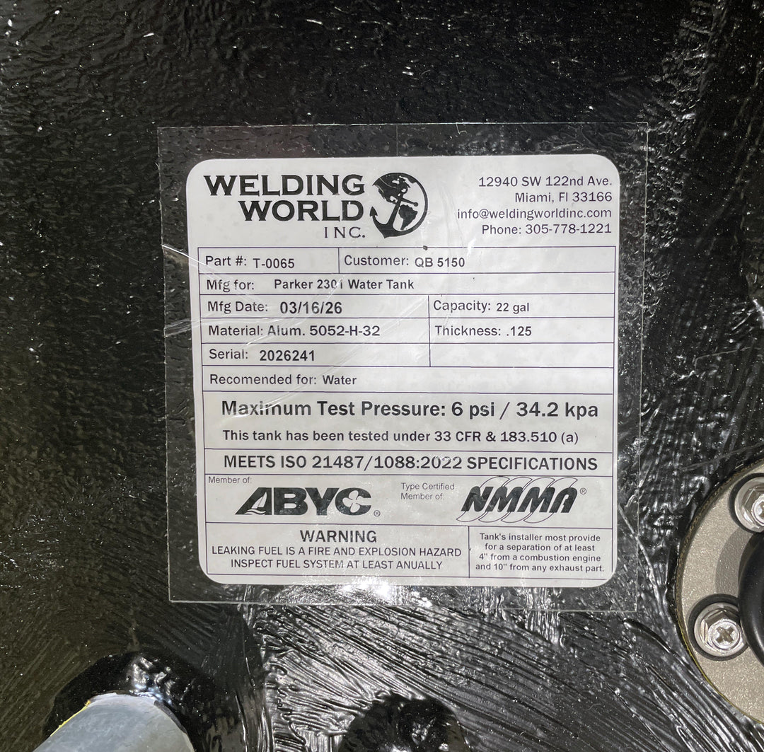 Close-up of the Welding World Inc. manufacturing label for a Parker 2301 (22 gal) water tank replacement. The label confirms the use of marine-grade 5052-H32 aluminum, a 6 psi pressure test certification, and compliance with ISO 21487/1088:2022 standards. This high-build Coal Tar Epoxy coated tank is verified for a guaranteed OEM fit, meeting all ABYC and NMMA specifications for marine freshwater systems.