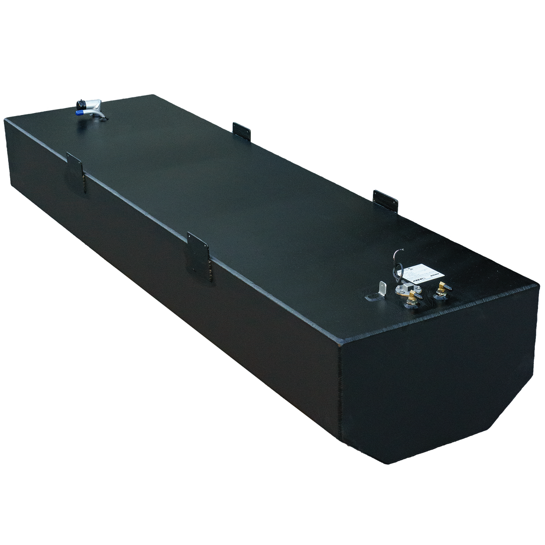 An elevated, angled view of a long, black, rectangular marine fuel tank. The top surface has a textured appearance and features multiple L-shaped black mounting brackets. Towards the left side, a silver-colored angled pipe fitting with a blue cap is visible. On the right side, a circular fitting with wires, two gold-colored nozzles, and a rectangular white label are present. The bottom right corner of the tank is beveled. The image is set against a black and gray checkered background