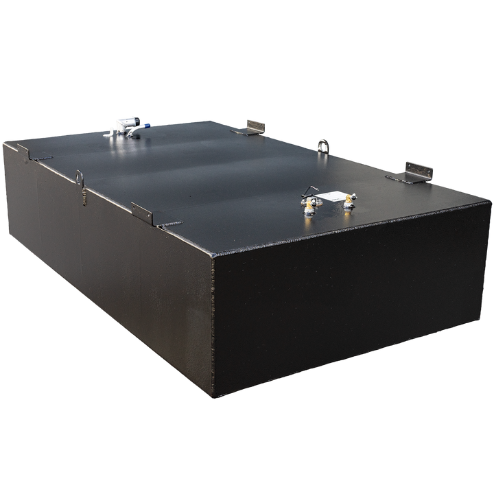 A black, rectangular fuel tank with a textured surface, possibly an OEM replacement, is angled on a black and grey checkered background. Its top surface features various metallic components including a blue-capped tube, brass-colored valves, and several metal brackets. A small white label is also visible on the tank's surface