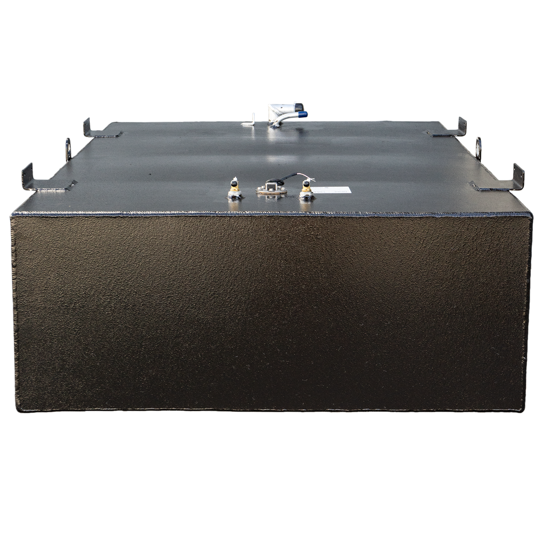 A black, rectangular fuel tank with a textured surface, possibly an OEM replacement, is positioned against a black and grey checkered background. Various metallic fittings, including a blue-capped tube, brass-colored valves, and several metal brackets, are visible on its top surface