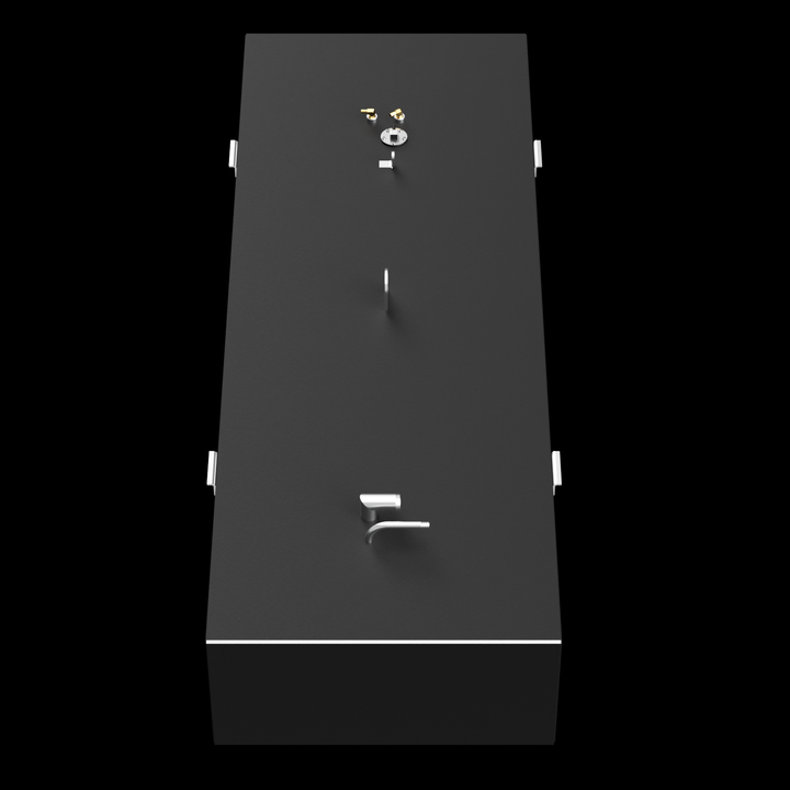 A top-down view of a dark grey, elongated rectangular fuel tank, set against a black background. The tank features golden-colored fittings, a circular silver cap, a straight pipe, an L-shaped pipe, and a D-ring on its top surface. White brackets are visible along the long sides of the tank, and a thin white line outlines the top edge