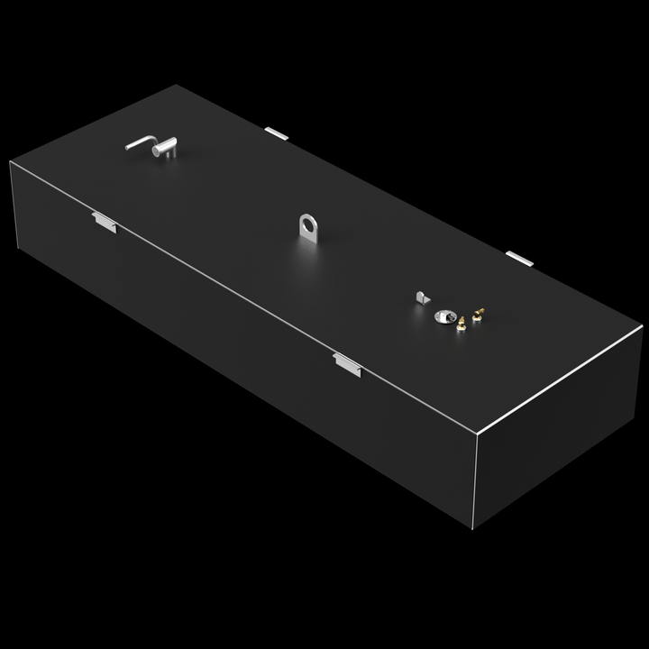 A dark grey, elongated rectangular fuel tank with various golden and silver-colored fittings on its top surface, including pipes, valves, and a large D-ring. Small, white, rectangular brackets are also visible along the edges of the top surface. The tank is positioned at an angle against a black background