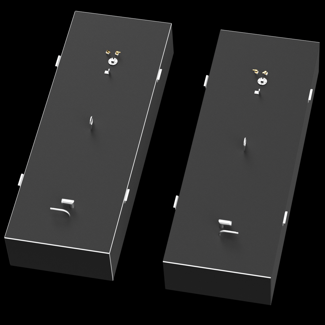 Two identical, dark grey, elongated rectangular fuel tanks are shown from an overhead, angled perspective. Each tank features golden-colored fittings, a circular silver cap, a straight pipe, an L-shaped pipe, and a D-ring on its top surface. White brackets are visible along the long sides, and a thin white line outlines the top edge of each tank. The tanks are set against a solid black background