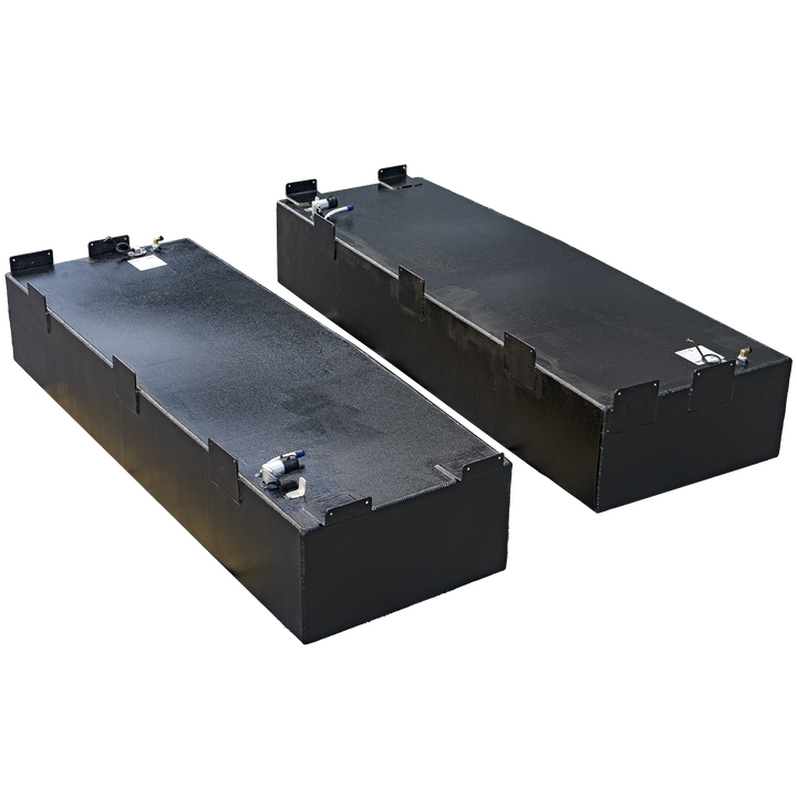 Two black, rectangular fuel tanks, likely for a boat, are displayed on a black and grey checkerboard background. The tank in the foreground is angled towards the left, revealing its top surface with various fittings and a label. The second tank is positioned behind it, angled towards the right, also showing its top with fittings. Both tanks have several protruding rectangular tabs or brackets along their sides