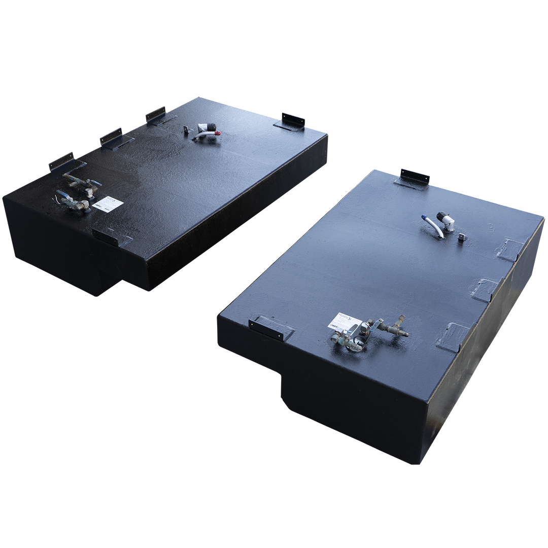 A pair of black, coated saddle fuel tanks, presented as a matching port and starboard set against a checkered background. The tanks are positioned diagonally, each featuring a rectangular body and a step-down notch on its lower inboard side. The tank in the foreground is shown from a high, front-three-quarter angle, revealing a prominent cluster of fuel valves, a sending unit, and a white label. The second tank, in the background, is viewed from the rear, showing its respective set of fittings