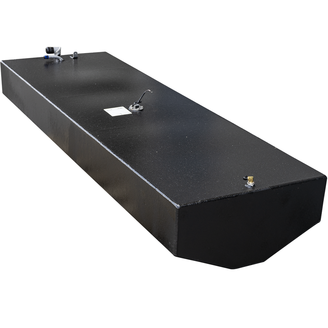 A long, rectangular, black fuel tank with a textured surface, shown against a checkered background. The top surface features various metal fittings, including a white and blue hose connection, a circular gauge with wires and a white label, and a small brass-colored post. The tank has a slight curve along its bottom edge