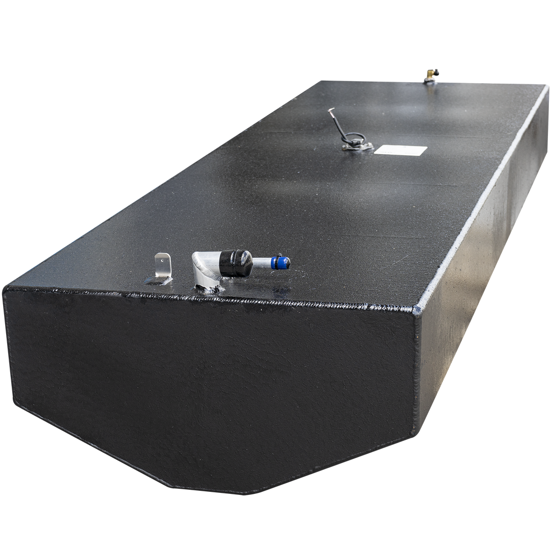 A long, rectangular, black boat fuel tank with a textured surface. Various metal fittings are visible on its top, including a hose connection with a blue cap, a small U-shaped bracket, a circular sensor with wires and a white label, and a small golden post. The bottom of the tank has a curved edge