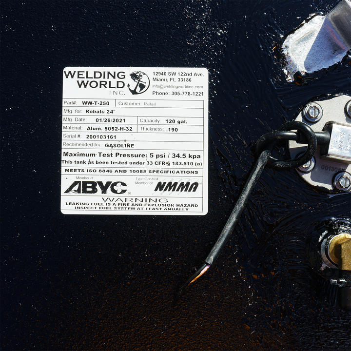 Label on a 120-gallon OEM replacement fuel tank for a Robalo 24' boat, manufactured by Welding World Inc. The label includes details such as part number, manufacturing date, materials, maximum test pressure, and safety warnings regarding fuel leakage