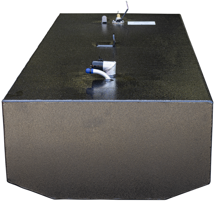 A black metal fuel tank with a textured finish shown from an angled rear view. The tank has a rectangular shape with chamfered corners on the front side. Visible on the top surface are several fittings, including a white pipe with a blue cap and a black sensor or valve. A mounting bracket is visible near the center of the top surface. The edges of the tank are welded, and the texture indicates a protective coating. The background is transparent, emphasizing the tank itself