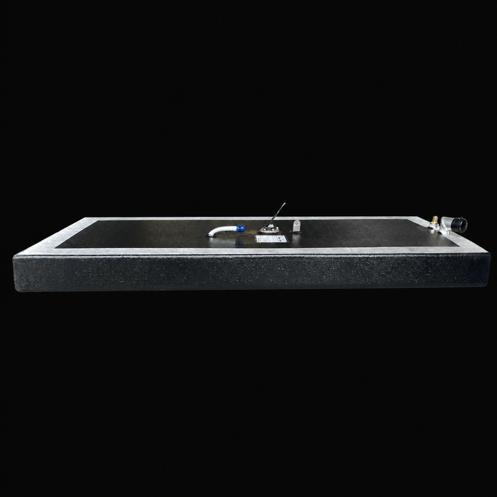 A full side-elevation perspective view of a low-profile rectangular black Scout 16 replacement marine fuel tank isolated against a solid black background. This 32-gallon capacity center-hull fuel cell is precision-fabricated by Welding World from heavy-gauge marine-grade 5052-H32 aluminum, showcasing a slim 7" depth designed to fit within tight factory bilge compartments. The structure features a semi-encapsulated design with a protective, textured black TarGard epoxy finish across the main surfaces while r