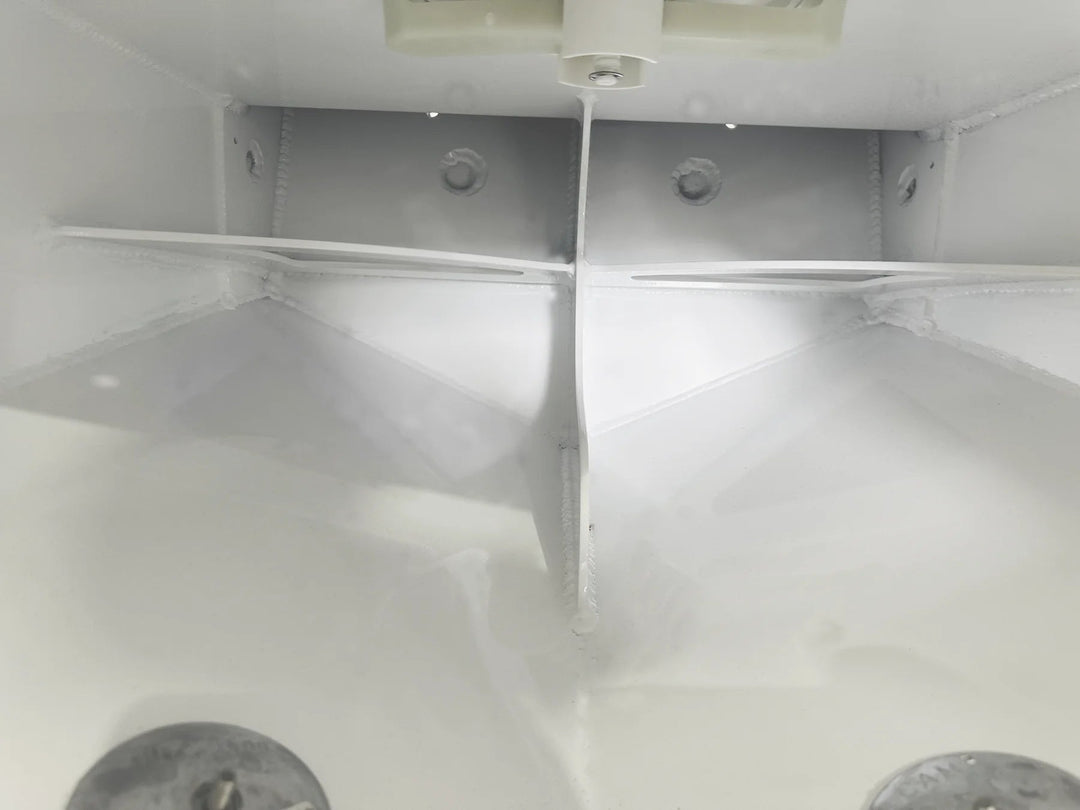 A view looking inside the flotation chamber through the access hatch, showing the internal aluminum welding and structural ribbing. Two zinc anodes are visible at the bottom.