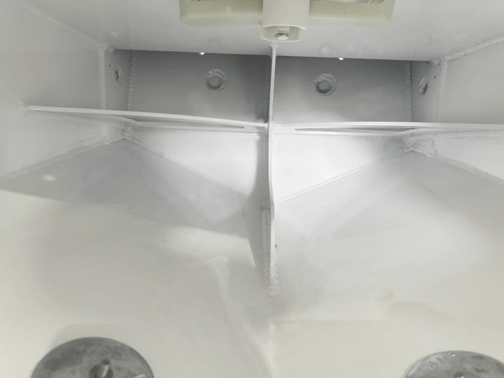 A view looking inside the flotation chamber through the access hatch, showing the internal aluminum welding and structural ribbing. Two zinc anodes are visible at the bottom.