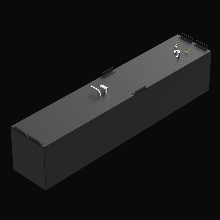 A long, rectangular black marine fuel tank with a matte texture, shown from a high front-left angle on a black background. The tank has multiple mounting tabs along the top edges. There are several fittings on the top surface near the far end, including a circular metal plate and two brass fittings. Two curved silver pipes are visible near the middle of the top surface