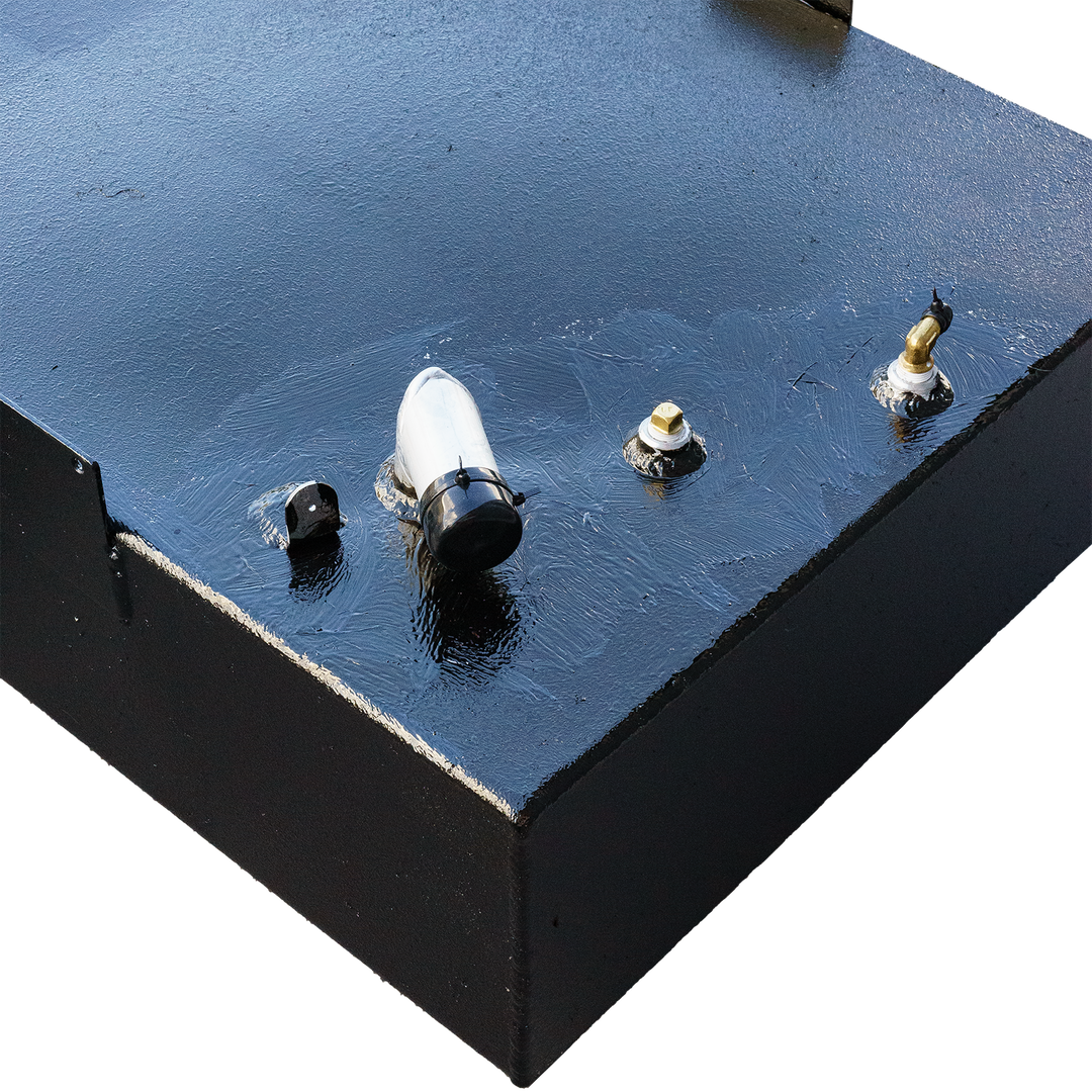 Close-up view of a 1978 SeaCraft 20' OEM replacement fuel tank, featuring a black surface with a fuel gauge, a vent, and a fuel line fitting