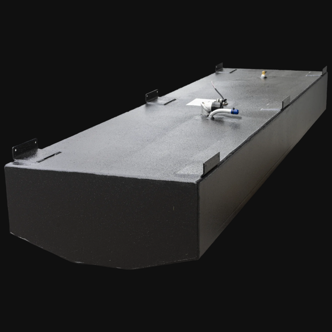 Black Built to OEM Specs fuel tank for a Boston Whaler Revenge 20 1977 model with a 44-gallon nominal capacity. The tank has a rectangular shape with a beveled front edge and a smooth textured finish. It features a small pipe on one end, a circular access port with a locking cover near the center, and two brass fittings on the opposite end. The tank is displayed at an angle against a black background
