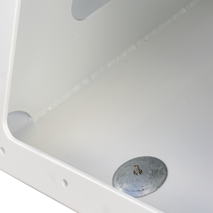 Close-up view of a Seacraft 23 twin engine high flotation bracket, featuring a circular metal plate with a central screw, mounted on a white surface