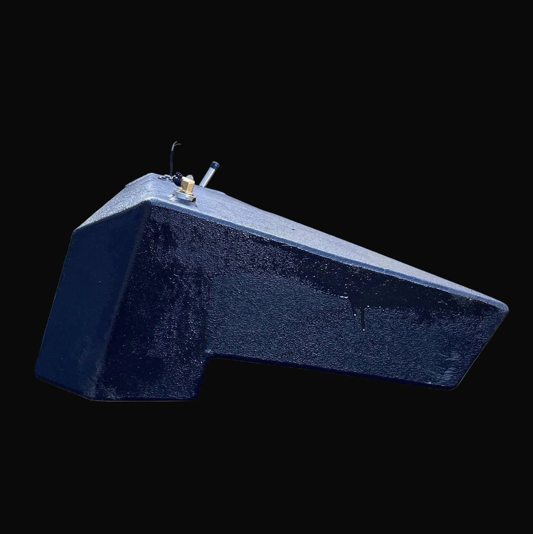 End profile view of the Seacraft 32 fuel tank, displaying the specific notched hull contour and angled bottom. The detailed shot highlights the texture of the black protective coating and the position of the top-mounted brass and aluminum fittings.