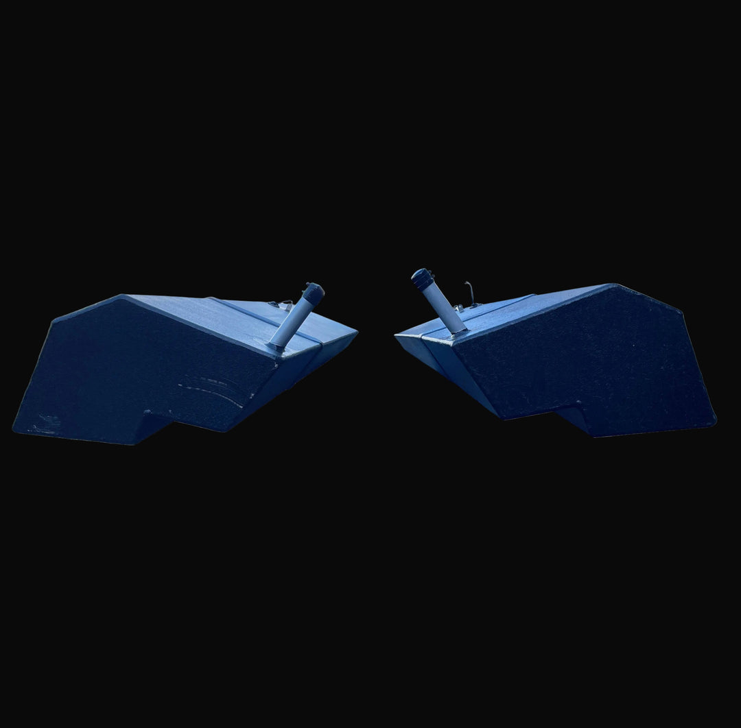 Front-facing view of the paired Seacraft 32 fuel tanks (Port and Starboard), illustrating the mirrored V-bottom design engineered to match the hull's deadrise. The image details the black-coated aluminum construction and the symmetrical orientation of the fill pipes.