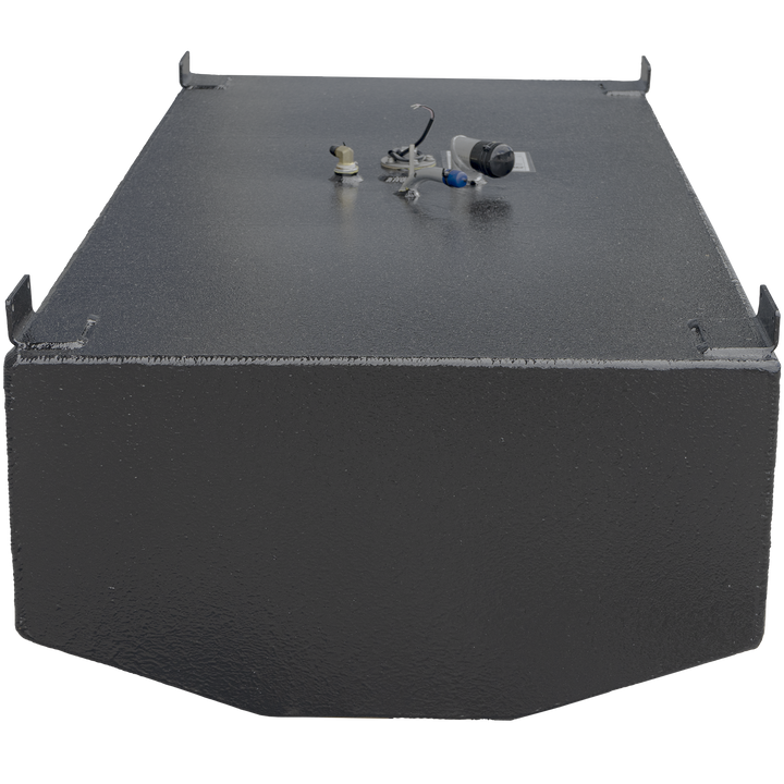 Photograph of a black metal fuel tank with textured surface and welded edges. The tank is rectangular with beveled corners on the front. Four mounting brackets extend from the top corners. The top surface features several fittings including a vent tube, sensor wiring, and a capped opening. The background is transparent, highlighting the tank's shape and details