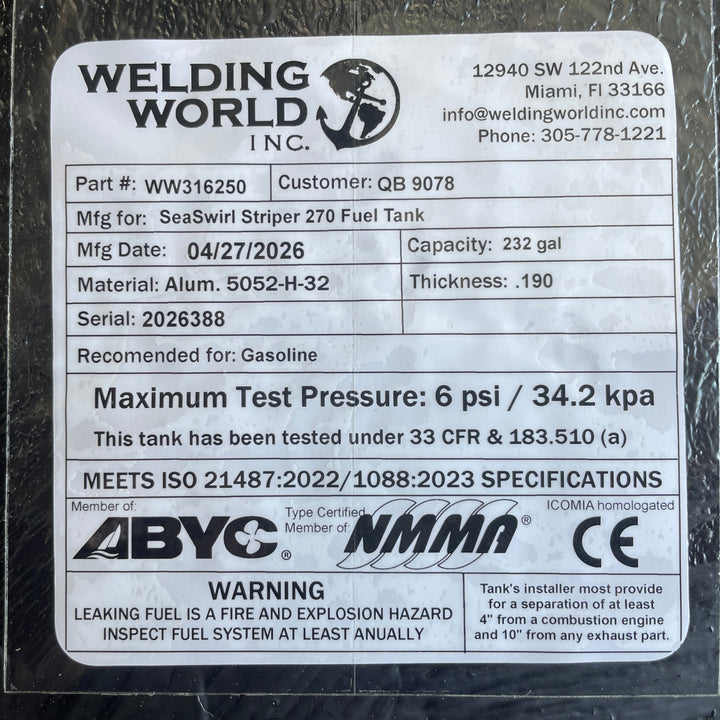Close-up photograph of the official Welding World Inc. manufacturing label for a SeaSwirl Striper 270 replacement fuel tank. The label certifies a 232-gallon capacity, heavy-duty 5052-H32 aluminum construction with .190" thickness, and a 6 psi maximum test pressure. It confirms compliance with ABYC, NMMA, CE, and USCG 33 CFR § 183.510(a) safety standards, including ISO 21487:2022 specifications for gasoline marine fuel systems.