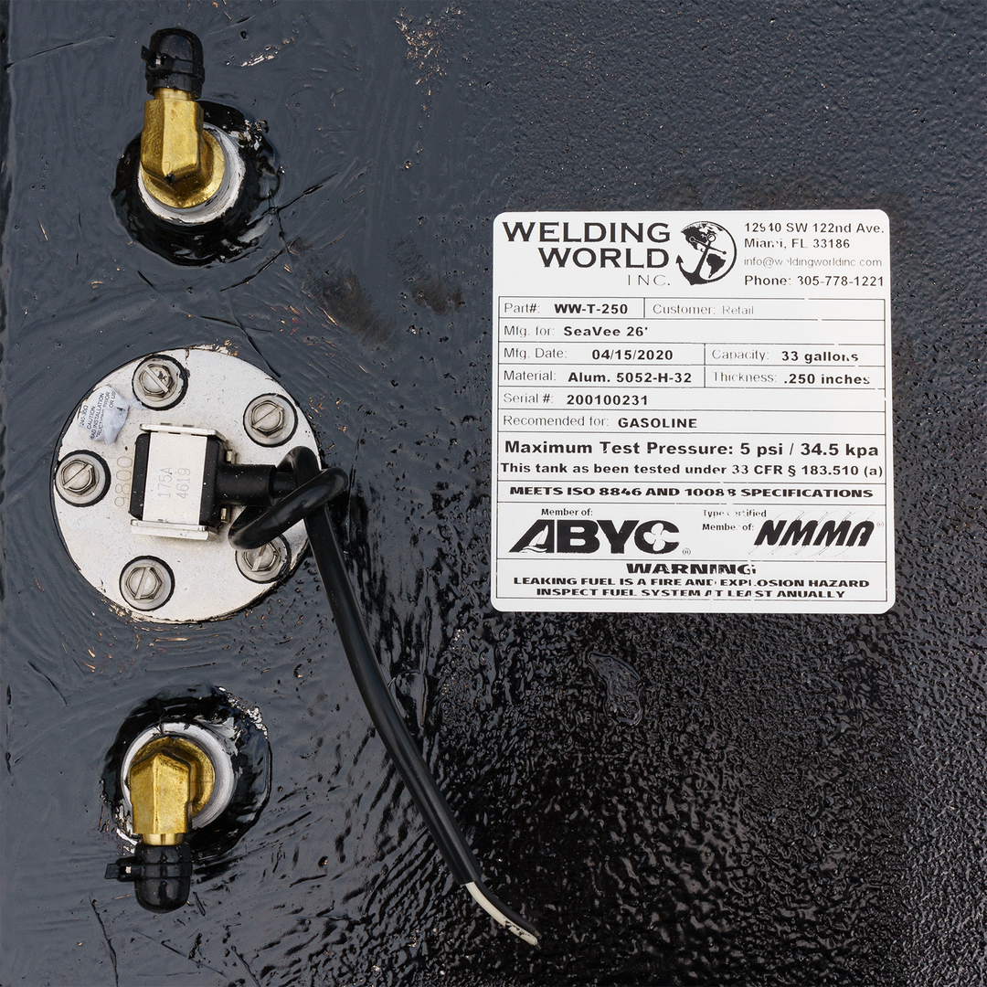 Close-up of a SeaVee 26' 2-Tank Combo fuel tank kit featuring a 100-gallon and a 33-gallon tank. The image shows the fuel tank's connection points, a label with manufacturing details, and a warning about maximum test pressure. The label includes the model number, manufacturing date, and specifications for gasoline use